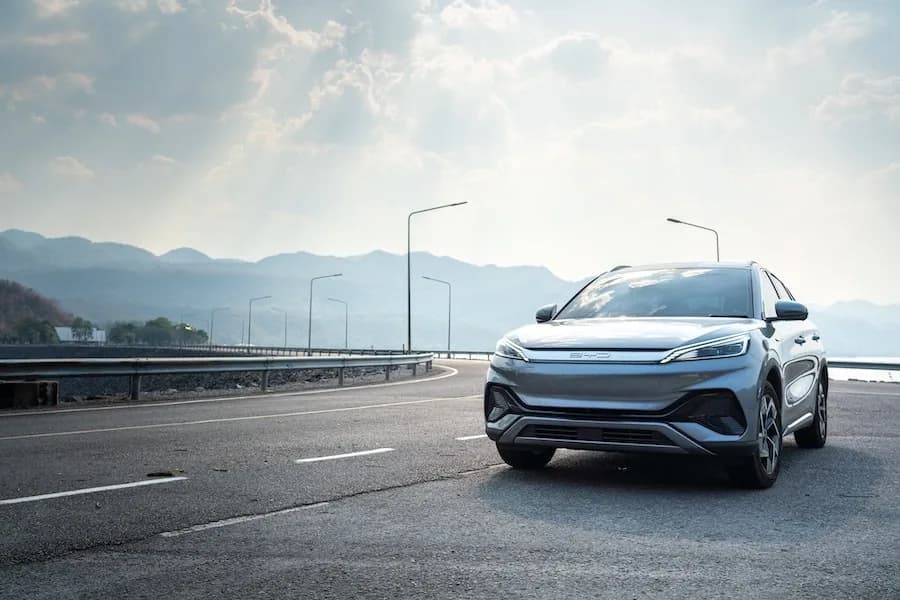BYD electric SUV driving on open road, representing rising BYD sales across Australia