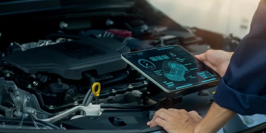 Technician performing electric vehicle servicing using digital diagnostics