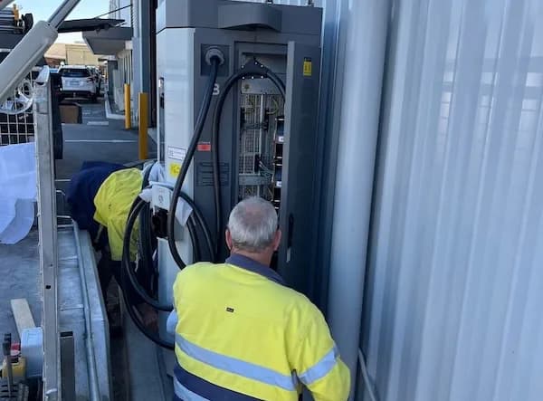 Electricians installing and wiring a high-capacity Ocular commercial EV charger at a Perth facility