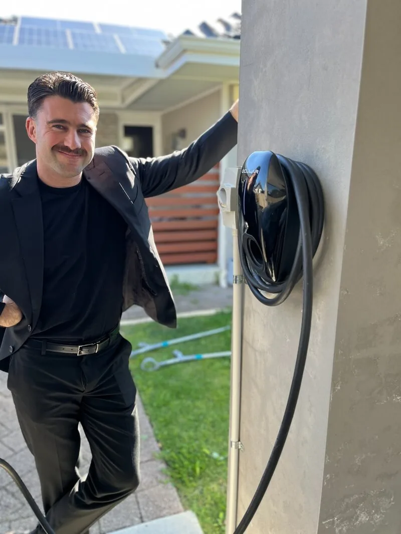 Morley homeowner beside the Ocular charger we installed on his carport pillar