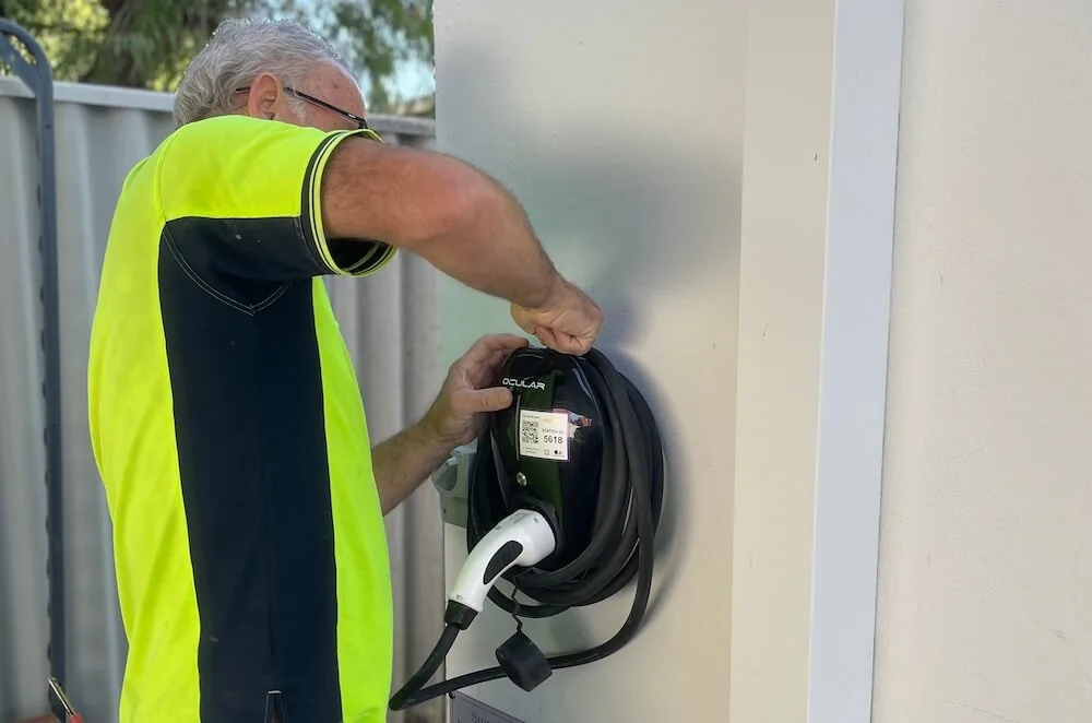 ChargingWA technician checking an Ocular home EV charger after installation in Perth